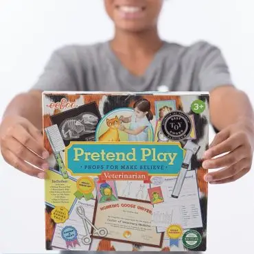Child holding Pretend Play Veterinarian set for imaginative learning and fun.