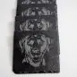 Set of black coasters featuring detailed dog engravings, perfect for pet lovers and stylish home decor.