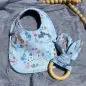 Baby bib and teething ring with cute animal print on soft blue fabric, ideal for newborns and infants.