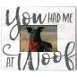 Dog wearing red scarf in field with 'You had me at Woof' text on rustic white background.
