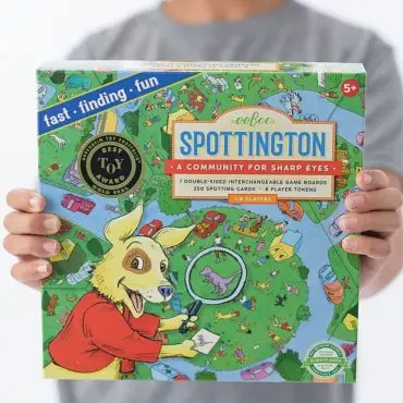 Child holding eeBoo Spottington game box, colorful design with playful illustrations for ages 5 and up.