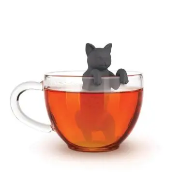 Cat-shaped tea infuser submerged in a clear cup of tea, adding a whimsical touch to your brew.