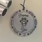 Round keepsake with Pawprints Left by You design, featuring paw prints and decorative heart accents.