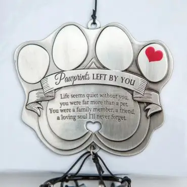 Pawprint memorial plaque with heartfelt pet loss message and red heart, symbolizing love and remembrance.