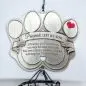 Pawprint memorial plaque with heartfelt pet loss message and red heart, symbolizing love and remembrance.