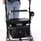 Person using a U-Step walker with storage pouch, designed for mobility assistance.