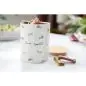 Ceramic jar with bone appétit design, filled with dog treats, on a kitchen counter.