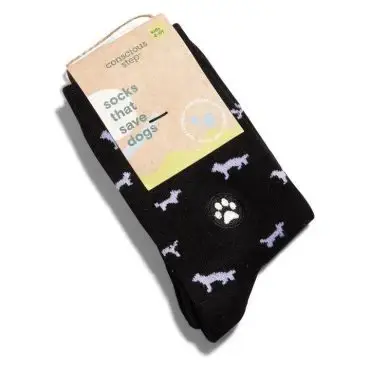 Black socks with white dog pattern and paw print, labeled Socks That Save Dogs from Conscious Step.