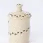 Speckled ceramic jar with paw print design on a white background, ideal for dog treats or kitchen storage.