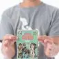Child holding Canine Chaos card game box with illustrated dogs on cover.