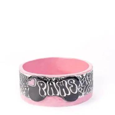Pink ceramic pet bowl with PAWS design and paw prints, perfect for stylish feeding.
