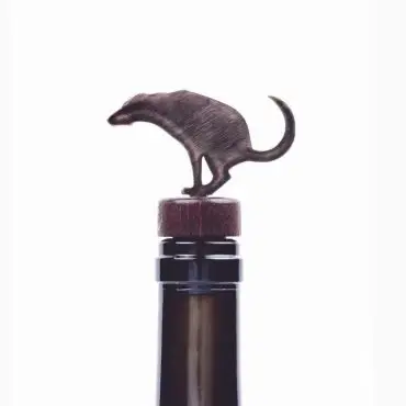 Unique animal-shaped wine bottle stopper, metal design atop a wine bottle.