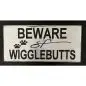 Beware of Wigglebutts sign with paw prints, playful warning for dog lovers.
