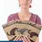 Person holding Blue Moose Metals bottle openers in packaging, wearing name tag reading Megan, Staff.