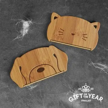 Cute cat and dog-shaped bamboo holders on grey fabric, finalist for 2023 Gift of the Year.