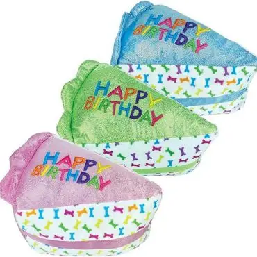 Three colorful plush birthday cake dog toys embroidered with Happy Birthday, featuring bone patterns.
