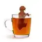 Cute dog-shaped tea infuser in a glass mug with tea. Fun kitchen accessory for tea lovers.