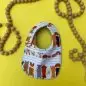 Baby bib with cute dog illustrations on a yellow background with wooden bead decor.