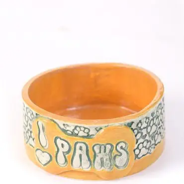Handcrafted ceramic bowl with I ♥ PAWS design and paw prints, ideal for pet lovers.
