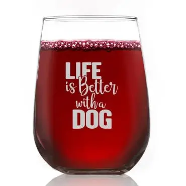 Stemless wine glass filled with red wine, featuring the phrase Life is Better with a Dog in white text.