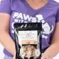 Woman holding a bag of Beyond Bones dog treats, promoting all-natural snacks made by individuals with disabilities.