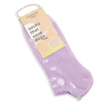 Purple socks with paw prints from Conscious Step, labeled socks that save dogs. Fair trade product.