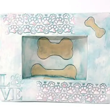 Decorative dog bone frame with paw prints and love text design, ideal for pet-themed home decor.