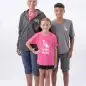 Three people smiling in Paws with a Cause shirts on a white background.
