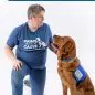 Person with assistance dog in Paws With a Cause attire, highlighting service dog teamwork and support.