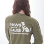 Person wearing a Paws with a Cause shirt, promoting assistance and facility dogs nonprofit.