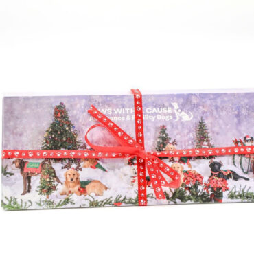 Gift wrapped in red ribbon displaying dogs, Christmas trees, and snow, promoting Paws with a Cause charity.