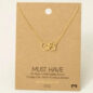 18K gold necklace featuring a heart and paw print pendant, displayed on a Must Have card.
