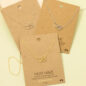 Gold and silver necklaces with heart and paw pendant on display cards, perfect for pet lovers.