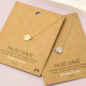 Gold and silver paw print necklaces on display cards with Must Have branding.