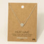 Elegant rhodium-plated necklace with paw pendant, displayed on a brown card. Perfect for pet lovers.