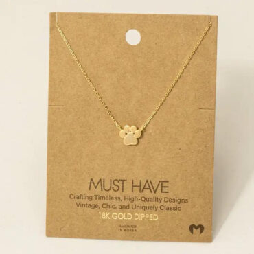 Gold necklace with a paw pendant on a cardboard display reading Must Have, 18K Gold Dipped, Handmade in Korea.