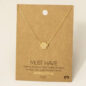 Gold necklace with a paw pendant on a cardboard display reading Must Have, 18K Gold Dipped, Handmade in Korea.