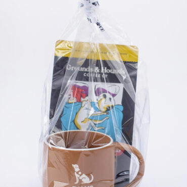 Gift set with Paws with a Cause mug and Grounds & Hounds coffee pack in plastic wrap. Perfect for dog lovers.
