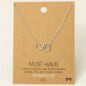 Rhodium plated necklace with heart and paw pendant on a cardboard display, handmade in Korea. Perfect for pet lovers.