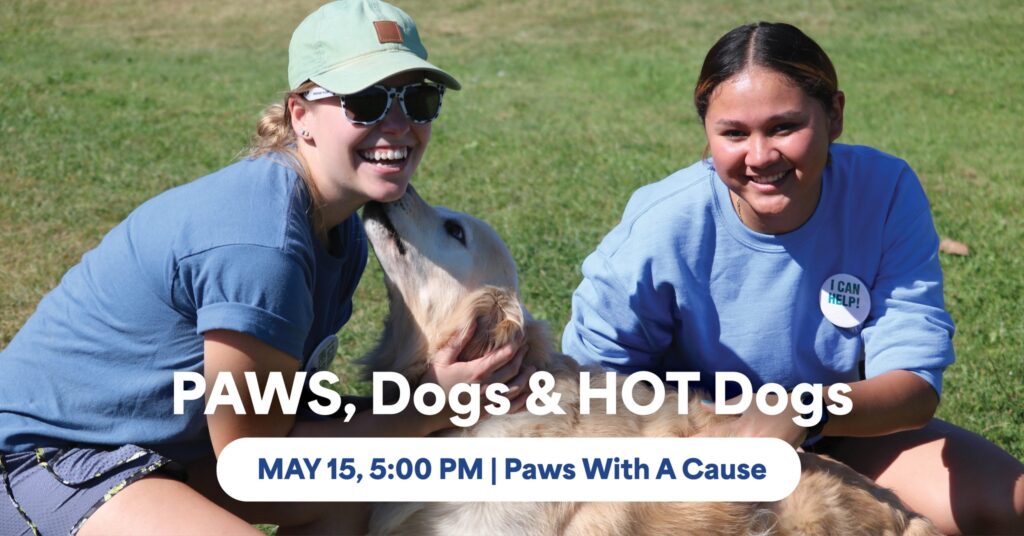 Two people smiling with a dog at Paws, Dogs & HOT Dogs event, May 15, Paws With A Cause.