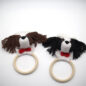 Crochet dog rattle teething rings for babies, brown and black puppy design with red bows, wooden handles.