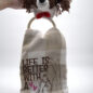 Crocheted dog head towel holder with motivational text Life is better with a best friend and hand-paw illustration.