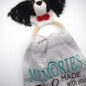 Crochet dog towel holder with embroidered text Memories made with your dog on striped fabric background.