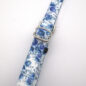 Floral blue and white keychain strap with metal buckle on a white background.